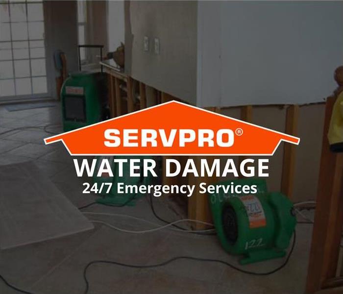 A room that has drywall cut, and green equipment. Says SERVPRO Water Damage 24/7 Emergency Services